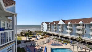 A hotel with a pool, beach view, and multiple balconies. - Seascape 2307 in Galveston (Galveston)