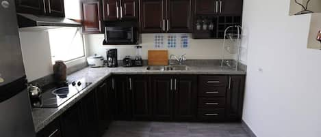 Fridge, microwave, stovetop, dining tables