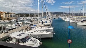 A marina with multiple sailboats docked, a no-entry sign, and buildings in the background. - Rental of a 2 rooms apartment, for up to 4 persons, in a residence with a pool, in the La... (BORMES LES MIMOSAS)