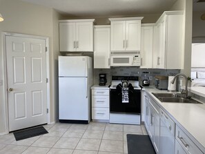 Enjoy cooking in this well-equipped kitchen with a refrigerator, stove, and sink.