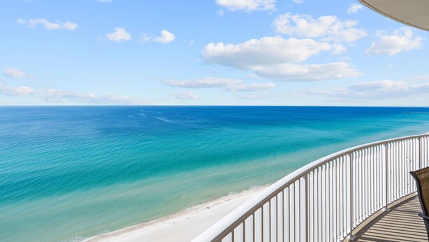 A balcony with a view of a beach and ocean. - 2 Bedroom in Ocean Villa Resort - Stunning views and all the comforts of home! (Panama City Beach)