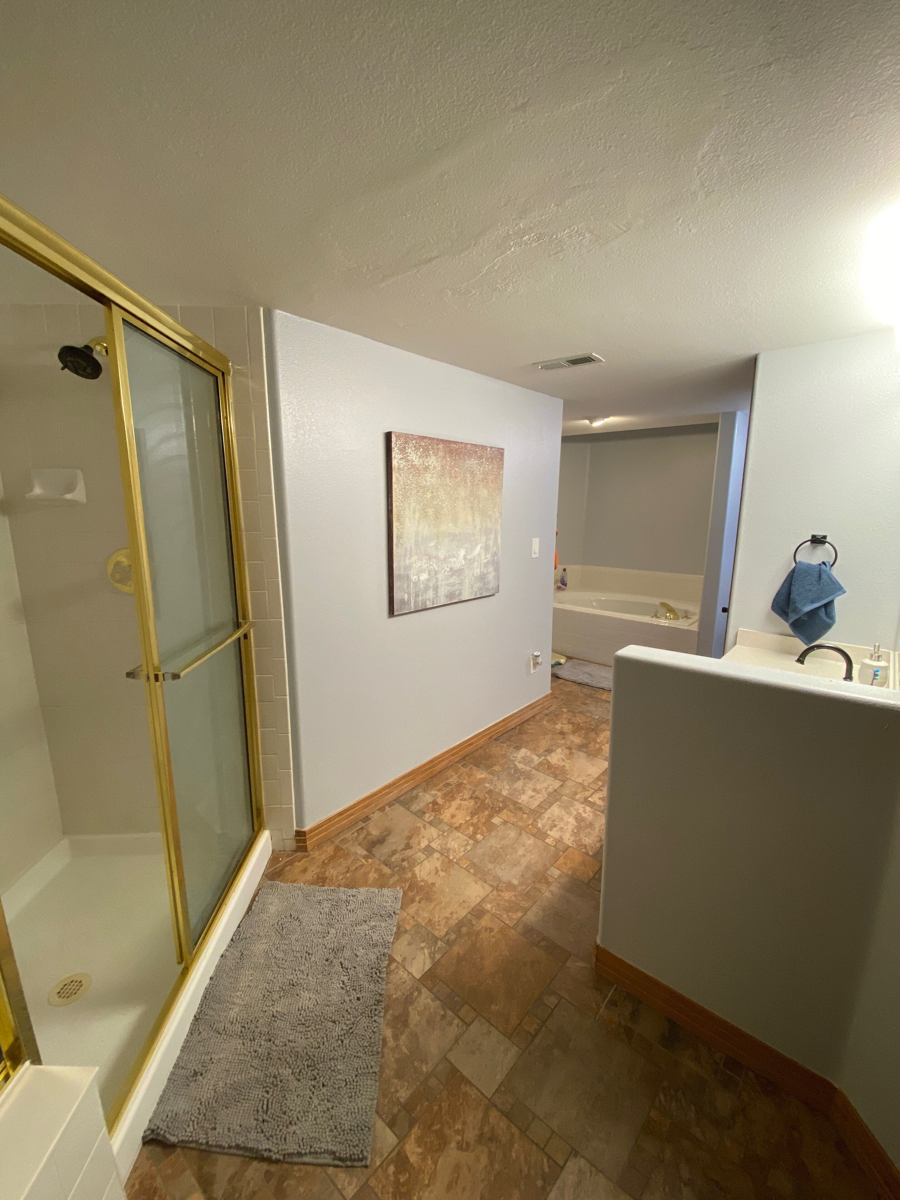 A bathroom with a shower, a sink, and a bathtub.