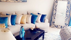 A living room with a sofa, coffee table, and decorative items. - Relax near downtown Atlanta (Lithonia)
