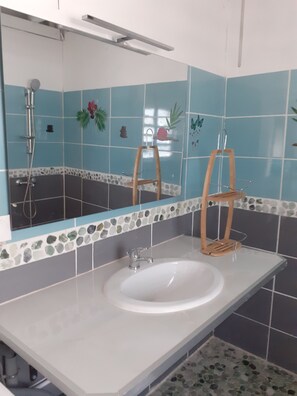 A bathroom with a white sink, a mirror, and a shower. - Villa le chalet des iles in the countryside with private pool (ST FRANCOIS)