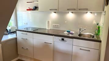 Fridge, stovetop, dishwasher, coffee/tea maker