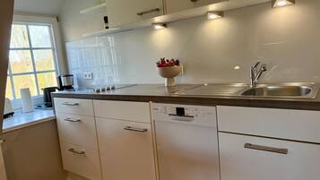 Fridge, stovetop, dishwasher, coffee/tea maker