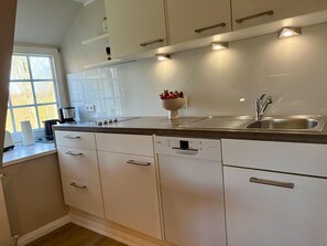 Fridge, stovetop, dishwasher, coffee/tea maker