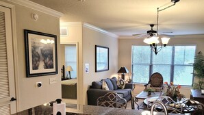 A modern kitchen with granite countertops, a stainless steel sink, and a dining area with a table and chairs. - 9 miles to Disney, washer dryer, full kitchen, private patio, 2 community pools (Davenport)