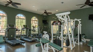 A gym with treadmills, weight machines, and exercise mats. - 9 miles to Disney, washer dryer, full kitchen, private patio, 2 community pools (Davenport)