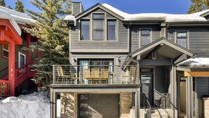A two-story house with a garage, a balcony, and a staircase leading to the upper floor.