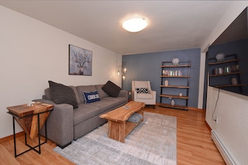 Living room with pull out sofa.  65 inch smart tv with streaming services.