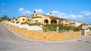 A building with a stone facade, arched windows, and a sign that reads 'San Marcos.' - Apartment "La Mandarina" with Mountain View, Pool, Wi-Fi, A/C & Terrace (Palmeria)