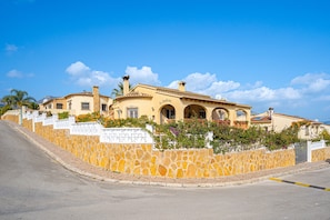 A building with a stone facade, arched windows, and a sign that reads 'San Marcos.'