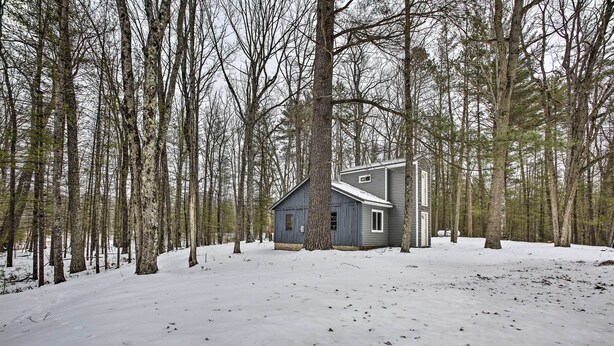 A cabin surrounded by a forest with snow on the ground. - Remote Michigan Retreat on 10 Acres w/ Grill! (Wellston)
