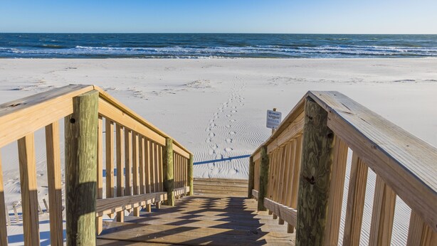 A wooden boardwalk leading to a sandy beach with ocean views. - REEL RETREAT-LAGOON FRONT PRIVATE COTTAGE, EXTRA AMENTIES, BEACH ACCESS, LOTS OF OUTDOOR FURNITURE (Gulf Shores)