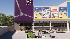 A modern hotel with a prominent 'Yes Hotel' sign, multiple 'Customer Service' signs, and a parking lot with cars. - Yes Hotel Pandi Bulacan (Pandi)