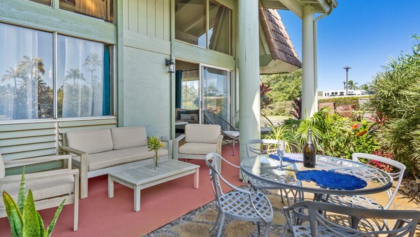 A covered outdoor seating area with a sofa, chairs, and a table. - (P17D) Hale Blue Hawaii 1Br with Loft, Puamana, Pool, Wifi (Princeville)