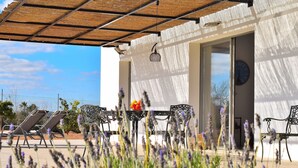 An outdoor seating area with chairs and a table, surrounded by lavender plants. - Son Alcaines Petit 249 cosy finca with private pool, terrace, barbecue and WiFi (Sineu)