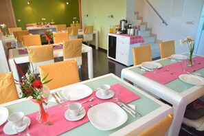 A dining area with tables set for four, each with white plates, cups, and cutlery. - B&B Boutique Eluize Dubrovnik (Dubrovnik)