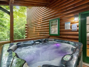 A hot tub in a wooden cabin with a view of the forest. - Lazy Bear Cove - Blue Ridge, GA (Epworth)