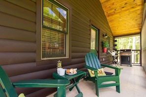 Relax in a cabin-style retreat with a deck offering a serene view of the surrounding greenery.