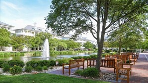 A serene courtyard with a pond, benches, and a fountain. - Beautiful 3 BR 2 BA Unit in Amenity Filled Sunset Island (Ocean City)