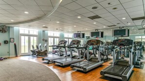 A gym with treadmills, elliptical machines, and weight equipment. - Beautiful 3 BR 2 BA Unit in Amenity Filled Sunset Island (Ocean City)