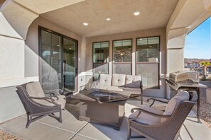 An outdoor patio with a seating area, a grill, and a view of the surrounding landscape. - Escondido 2343 & 2355 Retreat, Connected homes with 10 Bedrooms, sleeps 40, and endless amenities (Washington)