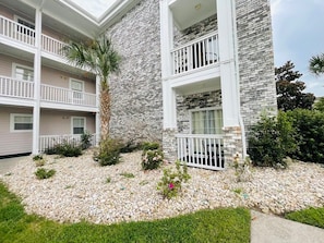 Stunning multi-story building with a flat roof and beautifully maintained garden area.