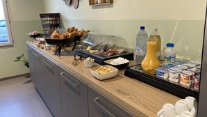 A breakfast buffet with pastries, cheese, and drinks. - Hôtel de la Tour (La Tour-du-Pin)