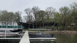 A dock extending into a calm body of water with boats moored at the end. - Beautiful sunsets. Maple hills condo owners (Annandale)