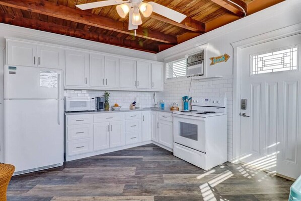 Enjoy cooking in this well-equipped kitchen with a microwave, stove, and sink.