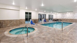 An indoor swimming pool area with two pools, lounge chairs, and a seating area. - La Quinta Inn & Suites by Wyndham Wenatchee (Wenatchee)