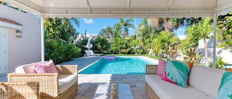 A heated pool, sun loungers