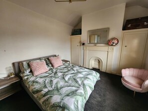 A bedroom with a bed, a chair, a fireplace, and a wardrobe. - Magnificent Milang, Lakes, sunsets, wineries (Milang)