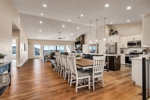 A spacious kitchen with a dining area, modern appliances, and a view of the outdoors. - Unique Lakeview Home with Indoor Pool in Basement! (Branson)