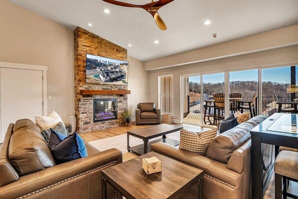 Flat-screen TV, fireplace, books, offices