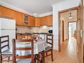 Cozy kitchen area with dining table, microwave, and sink.