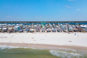 A beachfront hotel with multiple buildings, a sandy beach, and the ocean.