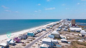 A coastal area with a beach, buildings, and a road. - Oceanfront/Zero Steps to Beach/Views/4BR (Gulf Shores)