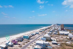 A coastal area with a beach, buildings, and a road. - Oceanfront/Zero Steps to Beach/Views/4BR (Gulf Shores)