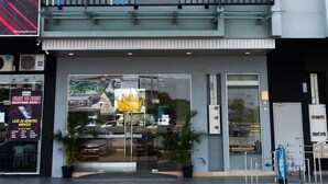 A modern hotel facade with a prominent sign for "The Crown KLIA". - The Crown Hotel Klia (Sepang)