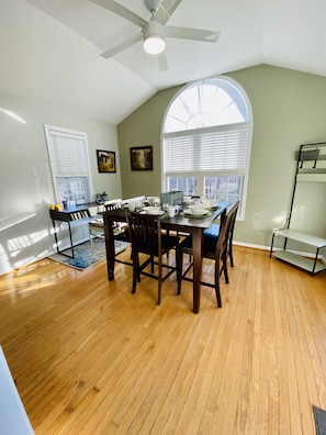 A dining area with a wooden table, chairs, and a ceiling fan. - **cozy country** *stargazing acre* (Franklinton)