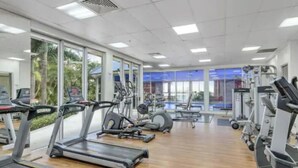 A gym with treadmills, elliptical machines, and stationary bikes. - Surfers Paradise Getaway: Amazing Resort Amenities (Surfers Paradise)