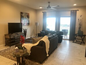 Relax in this inviting living room with a sofa, coffee table, and flat-screen TV.