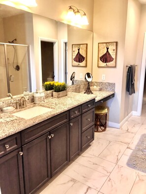Features a large vanity with double sink and spacious mirror area.