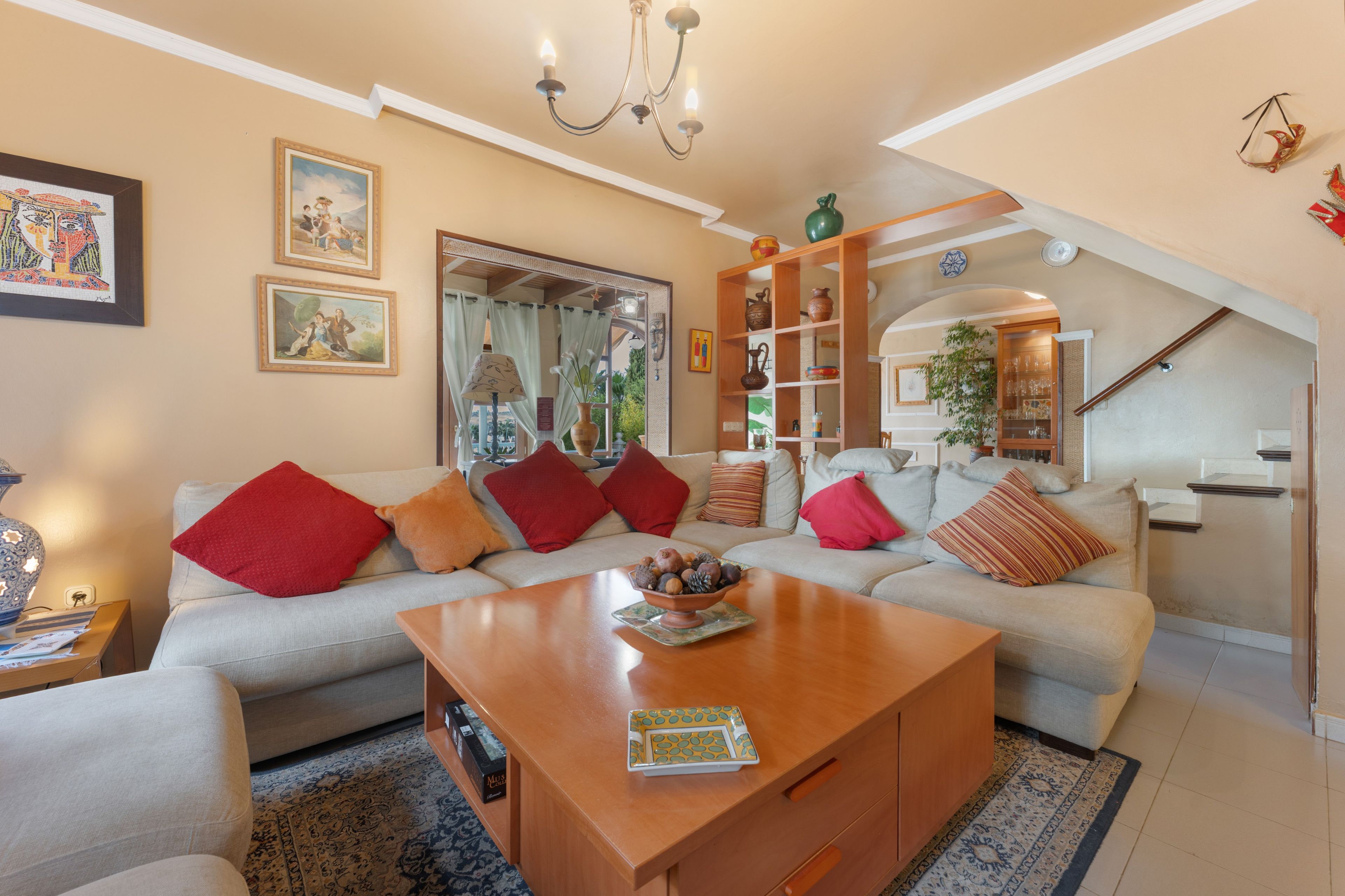 A living room with a sofa, coffee table, and a staircase.