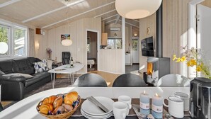 A modern living room with a fireplace, dining area, and kitchen. - Gorgeous home in Humble with kitchen (Humble)