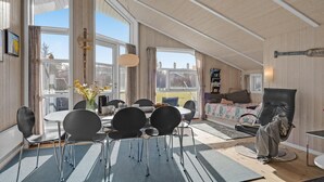 A spacious room with a dining area, a sofa, and a reading nook. - Gorgeous home in Humble with kitchen (Humble)