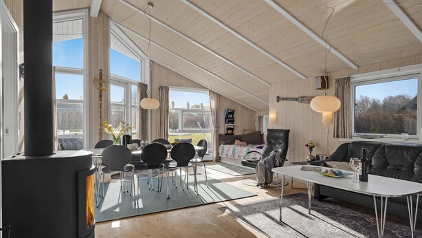 A spacious living room with a large window, a fireplace, and a cozy seating area. - Gorgeous home in Humble with kitchen (Humble)